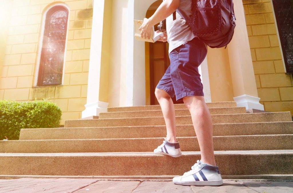 guy walking on a staircase symbolic of the financial ladder towards financial independence